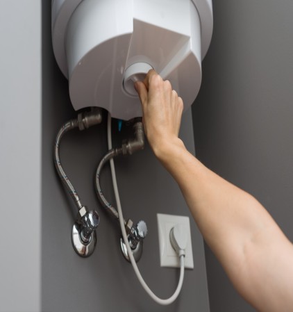 woman hands setting temperature of water in heater 2026 03 17 14 47 24 utc Large 1